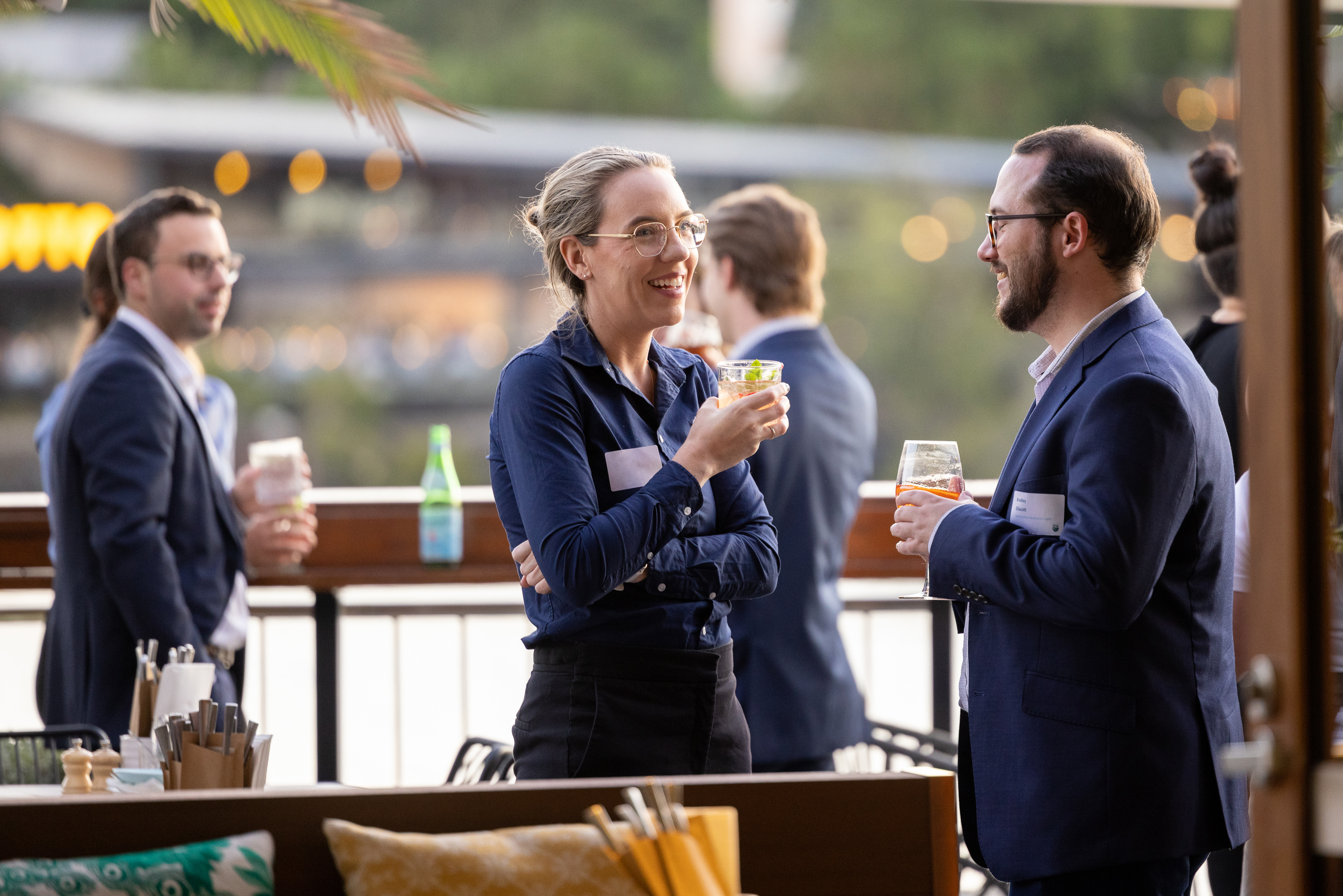 Young lawyers chatting with drinks in hand